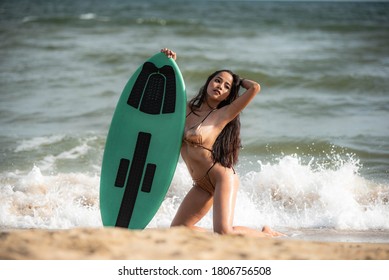 Sexy Asian Surfer Woman In Bikini Swimwear With Surfboard On The Beach/Extreme Sport On Summer Holiday Vacation