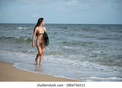 Sexy Asian Surfer Woman In Bikini Swimwear With Surfboard On The Beach/Extreme Sport On Summer Holiday Vacation