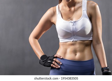 Sexy Asian Woman Abdominal With Six Pack Core Body Muscle Against Dark Background