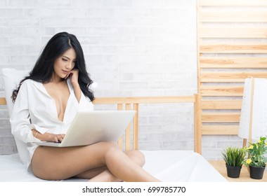 Sexy Asian Woman With Computer Notebook On Bed