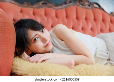 Sexy Asian Woman Lying On The Sofa