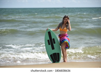 Sexy Beautiful Asian Surfer Woman In Bikini Swimwear With Surfboard On The Beach/Extreme Sport On Summer Holiday Vacation