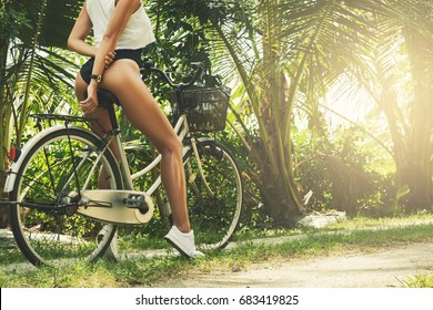 Sexy and beautiful woman with bicycle at hot summer day