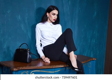 Sexy beautiful woman dark brunette hair wear clothes pants jacket trend accessory makeup perfect body model fashion office style businesswoman natural beauty casual silk texture elegant design formal.