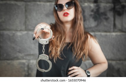 Sexy Beautiful Woman Holding Handcuffs.