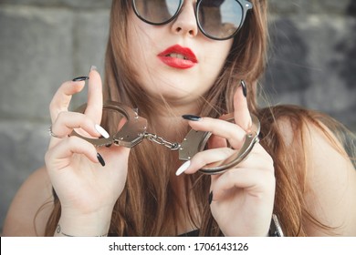 Sexy Beautiful Woman Holding Handcuffs.