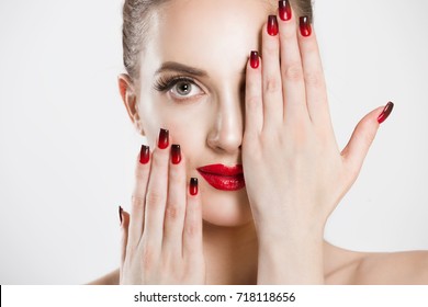Sexy Beauty Girl with false eyelashes Black Red gradient Lips, Nails. Provocative natural Make up. Luxury Woman looking at you camera hands on face Fashion Brunette Portrait isolated white background 