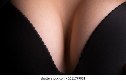 Sexy big breast. Female black bra lingerie. Sexiness and sensuality. Young attractive woman, seductive lady, chest in black brassiere. Female seductive breast of large size after surgery. Sexy volume