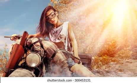 Sexy Biker Woman On The Autumn Background.