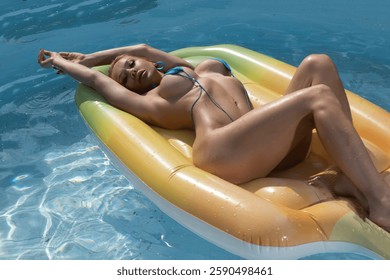 Sexy blonde in bikini at the pool.