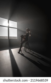 Sexy Blonde In Harness On A Black Cyclorama