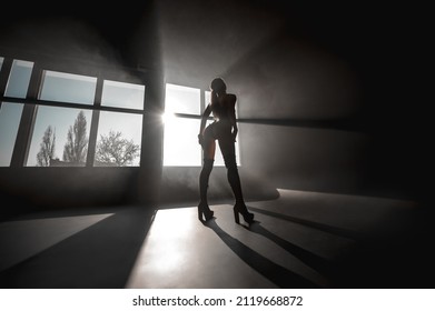 Sexy Blonde In Harness On A Black Cyclorama