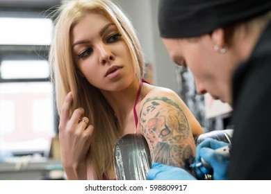 Sexy blonde posing in tattoo studio