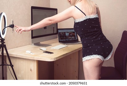 Sexy Blonde Woman With A Beautiful Legs And Mini Shorts Using Smartphone In Online Video Chat. Sex Concept.