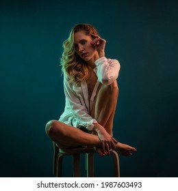 Sexy Blonde Woman Close Up Portrait Wearing White Shirt. Colorful Gel Photography.