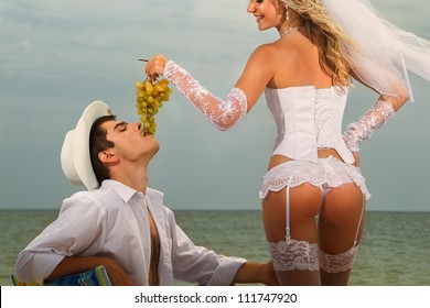 Sexy Bride Feeding Her Groom With Grapes