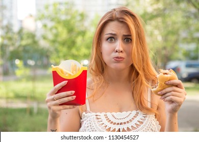 Sexy Brunette Plus Size Model Eating Burger And Fries As Her Diet Cheat Meal. Outdoors. Copy Space