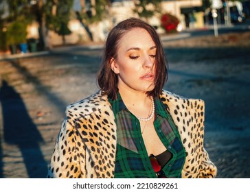 Sexy Brunette Woman In Fashionable Vintage Cheetah Print Coat Posing At Golden Hour In Sunlight In Los Angeles