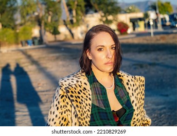 Sexy Brunette Woman In Fashionable Vintage Cheetah Print Coat Posing At Golden Hour In Sunlight In Los Angeles