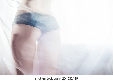 sexy bum in black pants hiding in tulle of gorgeous elegant lady glamor  girl with excellent fitness buttocks having fun happy standing back to camera on window light copy space background closeup