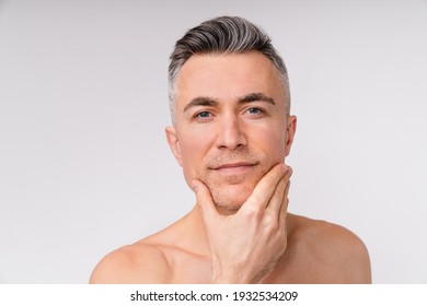 Sexy caucasian man looking into a camera shirtless isolated over white background