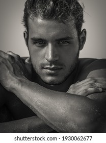 Sexy Closeup Portrait Of Handsome Topless Male Model With Beautiful Eyes Looking Into Camera At The Beach. Black And White.