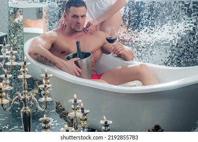 Sexy Couple In Bathroom. Man Relaxing Bath With Wine. Relationships Of Lovers.