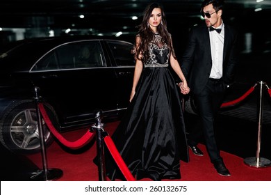 Sexy Couple In The Car. Hollywood Star. Fashionable Pair Of Elegant People At Night City Street.