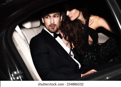 Sexy couple in the car. Hollywood stars.