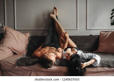 Sexy couple hugs on couch, erotica