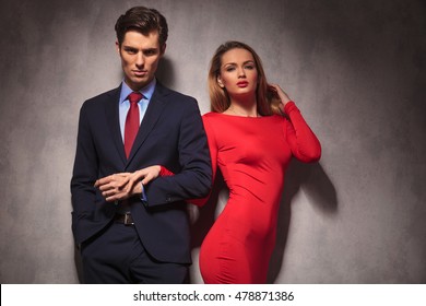 Sexy Elegant Couple Holding Hands, Man In Suit And Tie, Woman In Red Dress