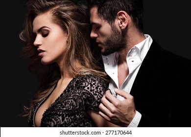 Sexy Elegant Couple In The Tender Passion. Beautiful Woman Near The Man.