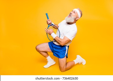 Sexy emotional cool pensioner grandpa practising rock music on a  sport equipment, stands on one knee, yell and shout. Body care, hobby, weight loss, lifestyle, strength and power, health