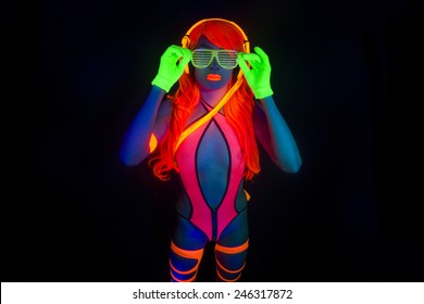 sexy female disco dancer poses in UV costume