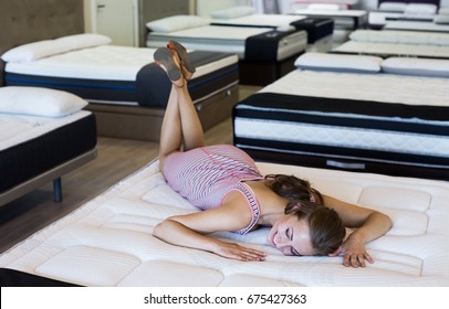 Sexy Female Lying On New Mattress In  Furniture Store And  Shopping