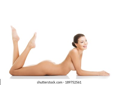 Sexy fit naked woman with healthy clean skin lying down, isolated on white 