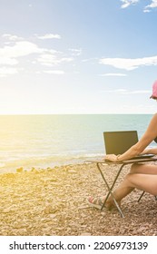 Sexy Freelance Girl In An Erotic Swimsuit Working At A Computer On The Ocean, Free Work Not Tied To A Place Of Residence