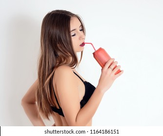 Sexy Girl In Black Lingerie Drinking Through A Straw From A Red Can