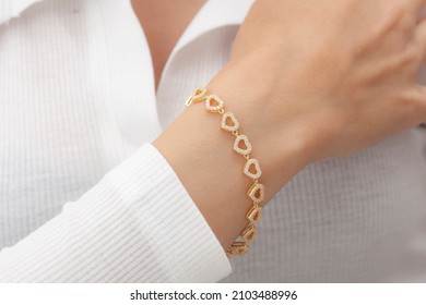 Sexy girl with heart bracelet on her wrist. Visual that can be used in e-commerce, online sales and social media.
					