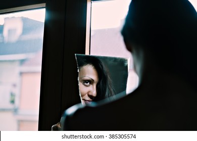 Sexy Girl Looking At Reflection In A Broken Mirror. Bad Luck