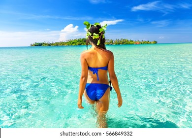 Sexy girl on tropical beach. Beautiful young woman enjoy a swim in the crystal clear sea ocean water tropical beach on background green tropic island