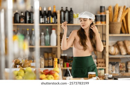 Sexy girl saleswoman dancing topless behind grocery store counter