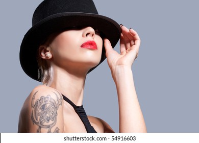 Sexy Girl Wearing A Black Hat, Isolated On Grey