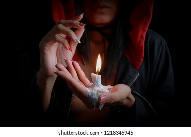 Sexy Girl In Witch Hoodie Holding Melted Candle. Look Like Super Natural Have Magic To Make A Wishes.