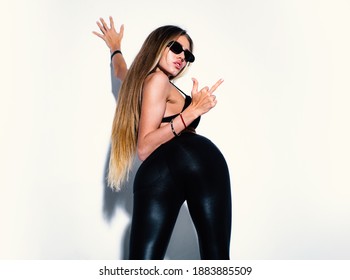 Sexy hipster woman showing tongue and middle finger, wearing sunglasses. Cheeky emotions, cool and crazy. Fuck you