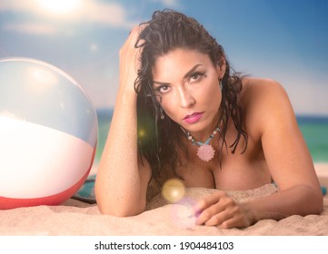 Sexy Latina Woman On The Beach With Beach Ball Running Her Hand Through Her Hair