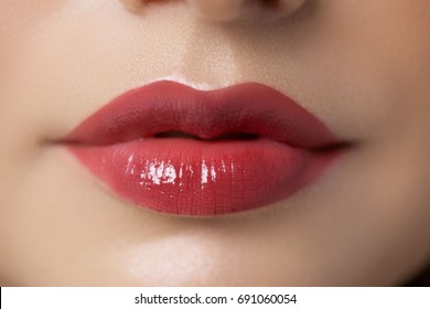 Sexy lips. Macro of woman's face part. Sexy glossy lip makeup. Beauty red lip makeup detail. Beautiful make-up close-up.Lipstick and lipgloss.chubby passionate lips
