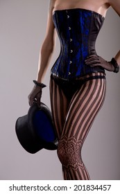 Sexy Magician Girl In Corset And Lingerie Holding Top Hat, Studio Shot 