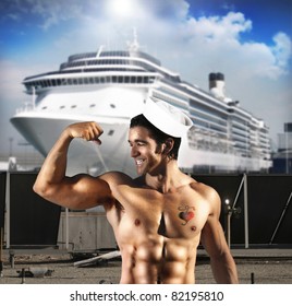 Sexy Male Model As Sailor Flexing His Bicep In Front Of Ship At Port With A Heart Tattoo On His Chest