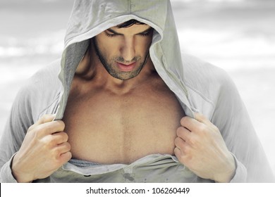 Sexy Man In Hooded Activewear Revealing His Muscular Chest